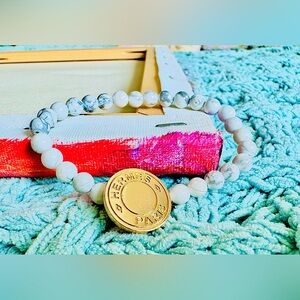 HERMES Bracelet with a Gold HERMES charm and White Howlite
Gemstone beads